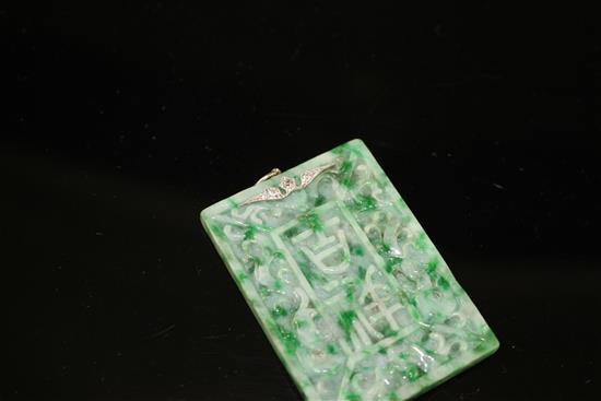 A carved jadeite and diamond set rectangular pendant, both sides decorated with Chinese characters and scrolls, 53mm,